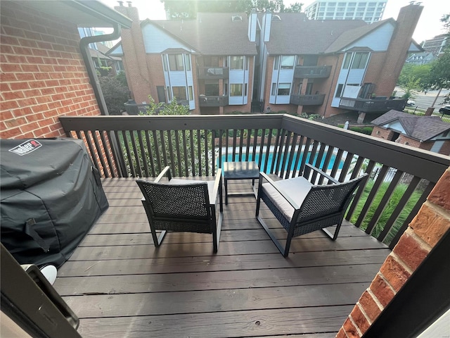 wooden deck featuring an outdoor living space and area for grilling