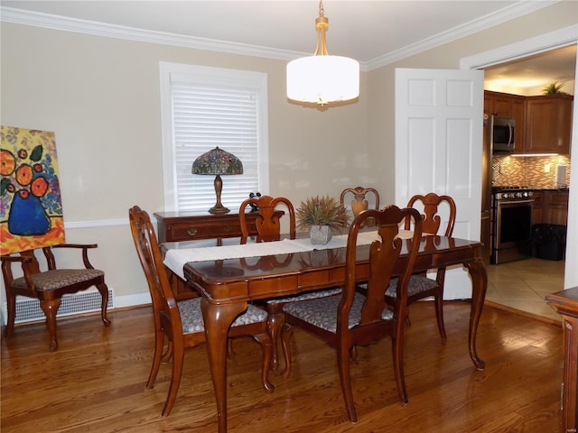 dining space featuring crown molding and dark hardwood / wood-style floors