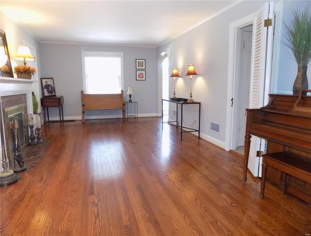 living room featuring wood-type flooring and crown molding