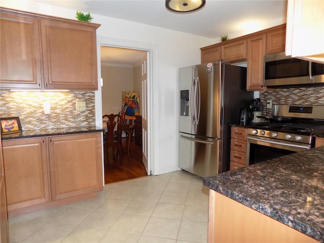 kitchen featuring tasteful backsplash, ornamental molding, appliances with stainless steel finishes, and light tile patterned flooring