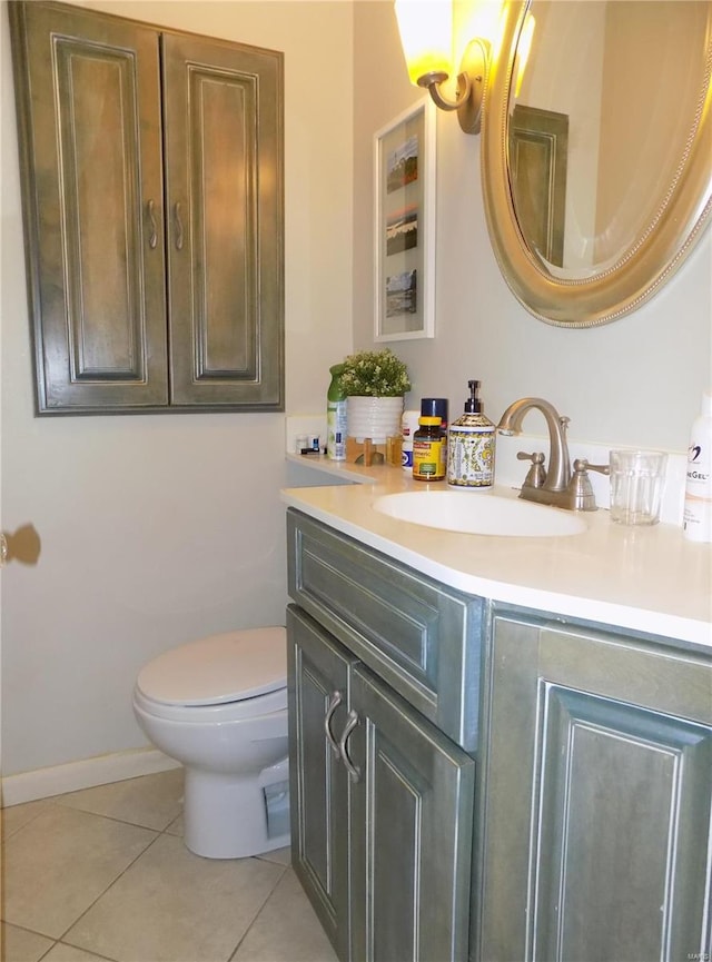 bathroom featuring vanity, tile patterned floors, and toilet