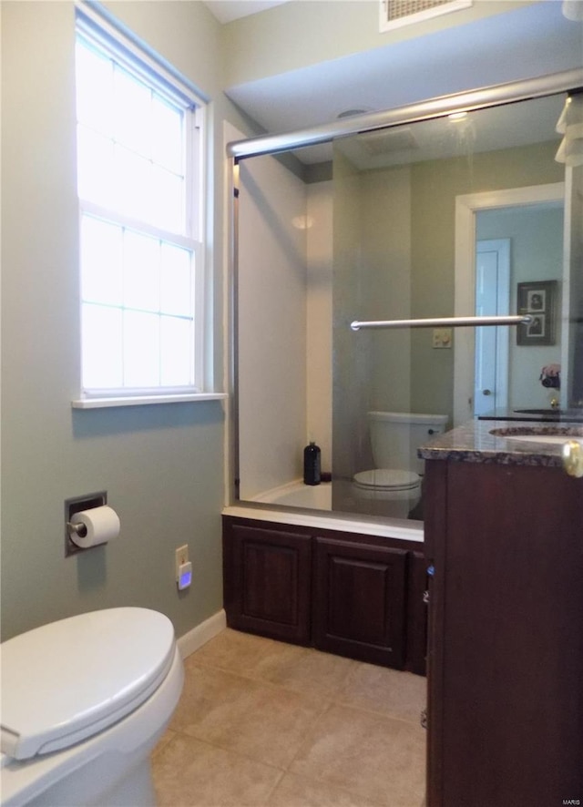 bathroom with vanity, tile patterned floors, and toilet