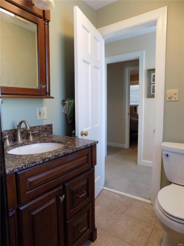 bathroom with vanity, tile patterned flooring, and toilet