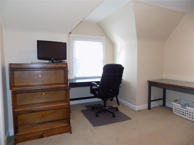 carpeted office with lofted ceiling