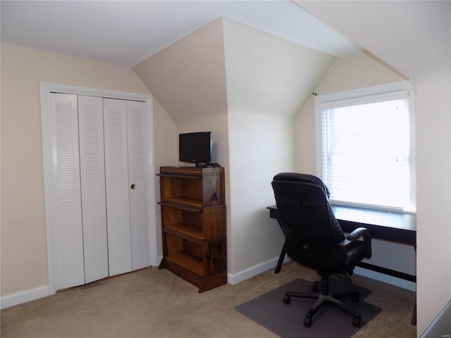 office area featuring lofted ceiling and light colored carpet