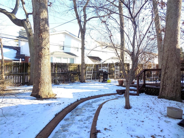 yard covered in snow featuring a wooden deck