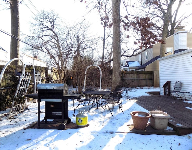 snow covered deck featuring a grill