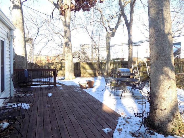 snow covered deck featuring area for grilling