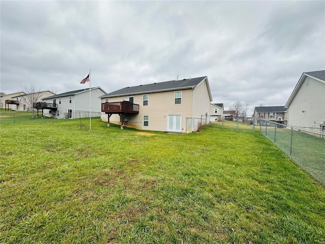 back of property with a lawn and a wooden deck