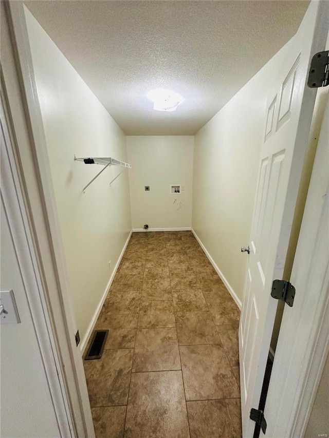 laundry room featuring a textured ceiling