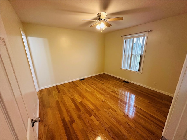 spare room with light hardwood / wood-style flooring and ceiling fan