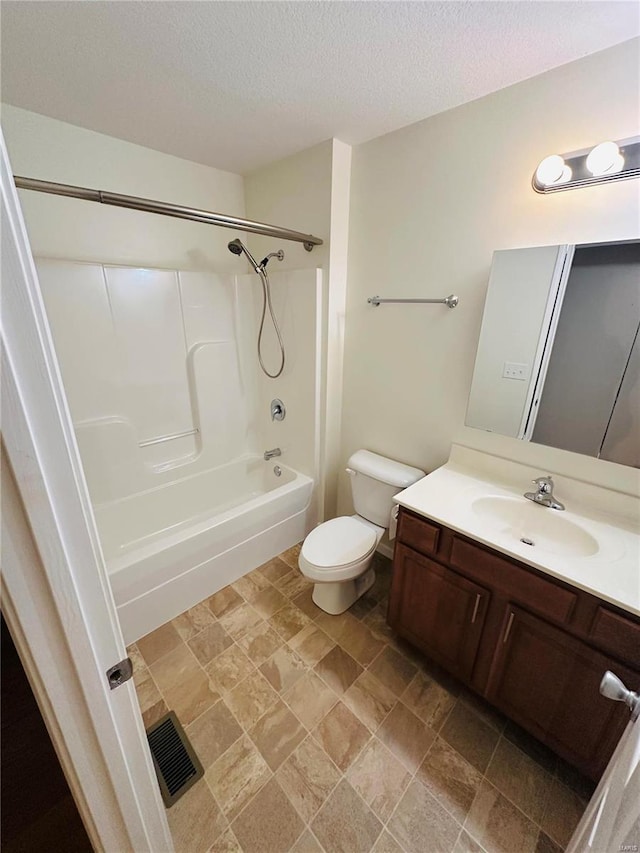 full bathroom featuring vanity, bathtub / shower combination, a textured ceiling, and toilet