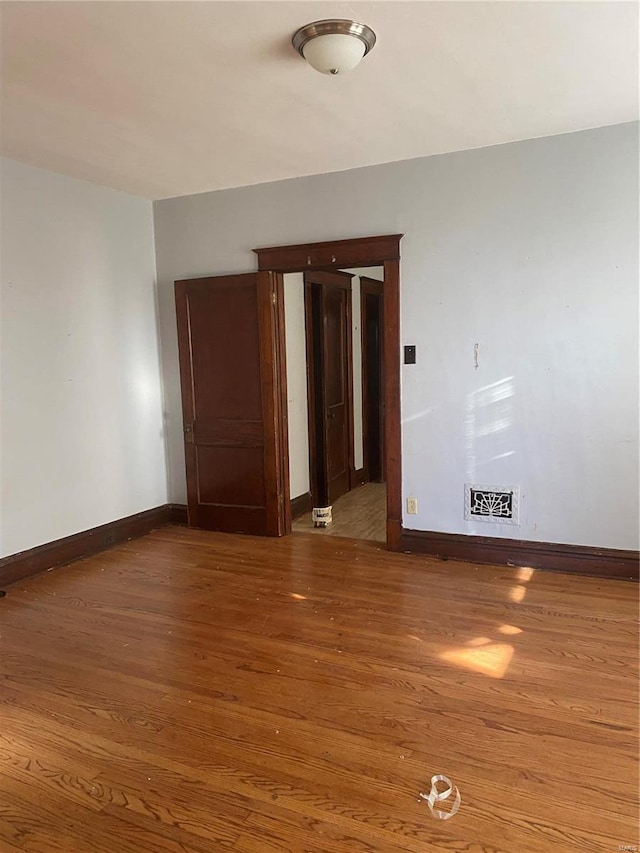 spare room featuring dark wood-type flooring