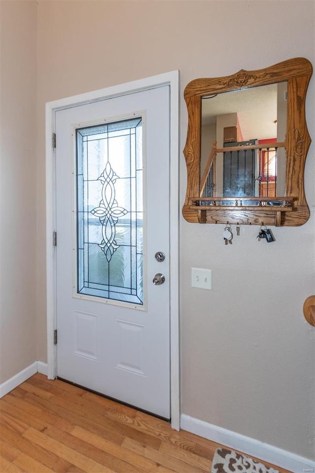 doorway with light wood-type flooring