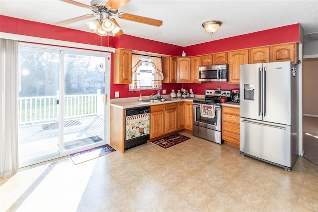 kitchen featuring ceiling fan, sink, and appliances with stainless steel finishes