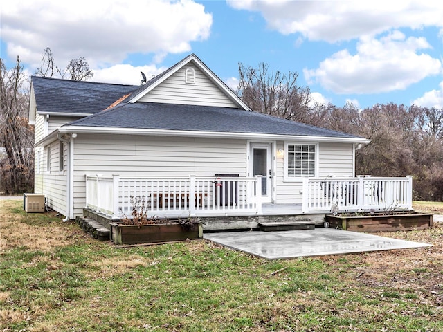 rear view of house with a yard, a patio, and a wooden deck