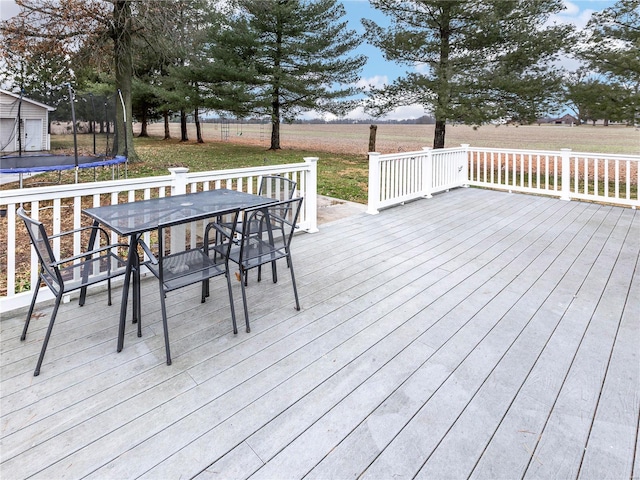 wooden deck featuring a rural view and a trampoline