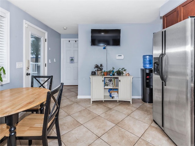 kitchen with stainless steel fridge and light tile patterned floors