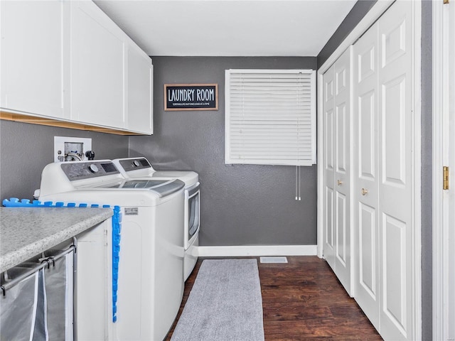 laundry area with dark hardwood / wood-style flooring, cabinets, and separate washer and dryer