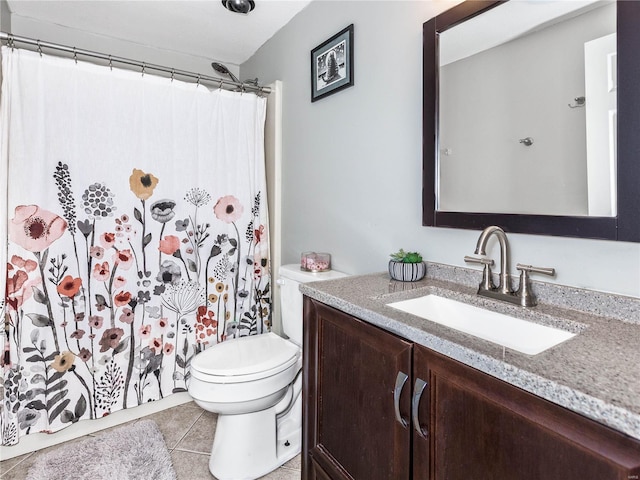 bathroom featuring tile patterned flooring, vanity, and toilet