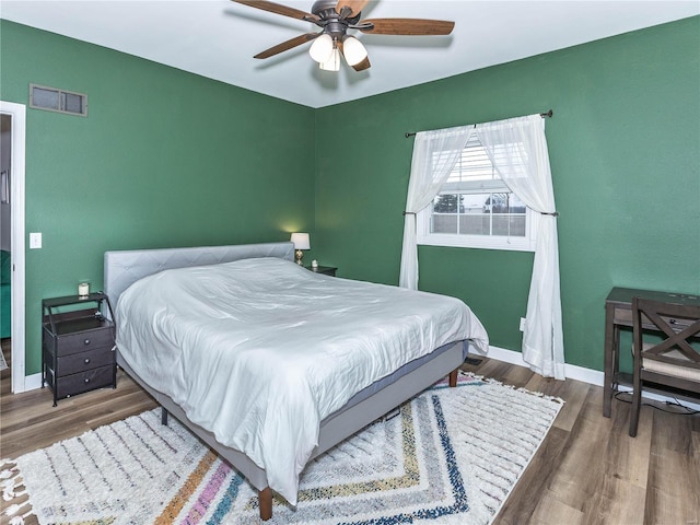 bedroom with ceiling fan and hardwood / wood-style flooring