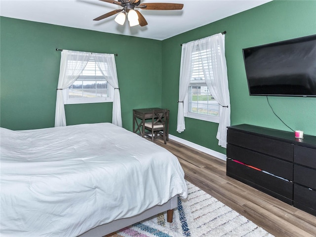 bedroom featuring hardwood / wood-style floors and ceiling fan