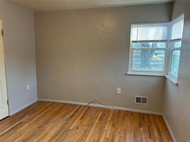 spare room featuring light wood-type flooring