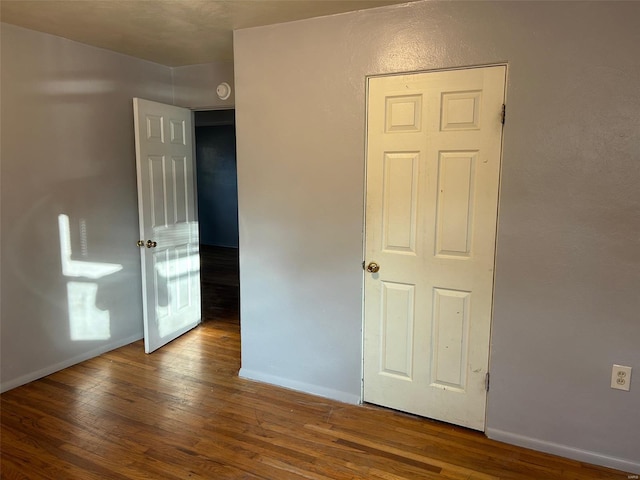 empty room with hardwood / wood-style flooring