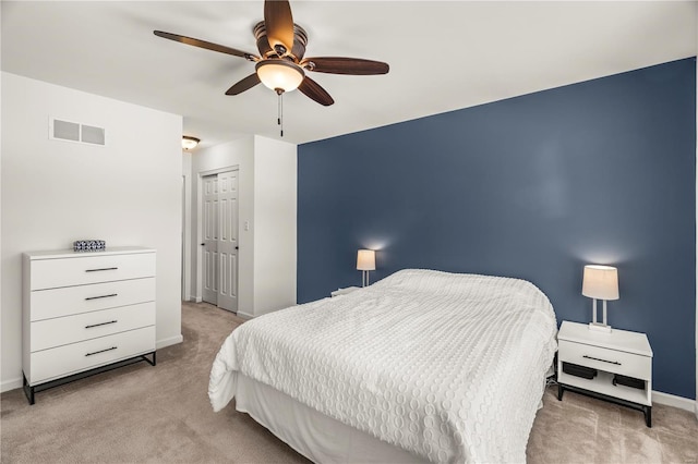 bedroom featuring ceiling fan and light carpet