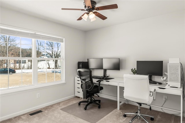 carpeted office space with ceiling fan