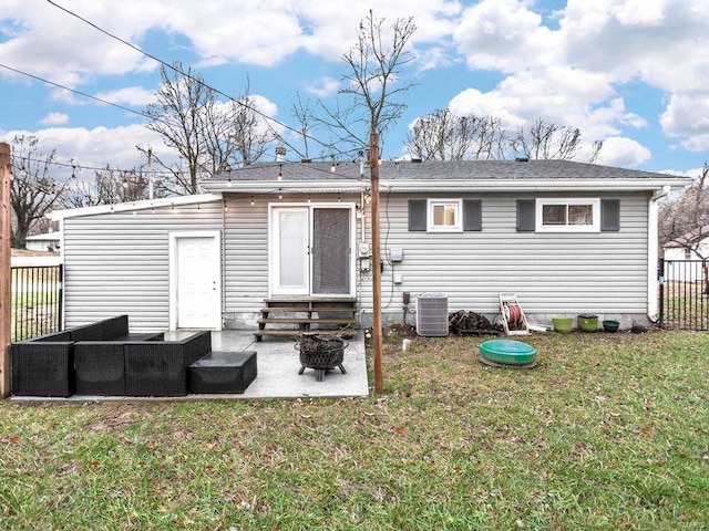 back of property with a lawn, cooling unit, and a patio