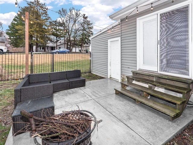 view of patio with an outdoor living space with a fire pit