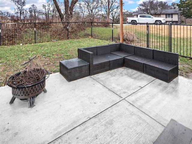 view of patio with an outdoor living space with a fire pit