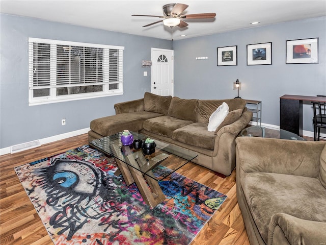 living room featuring hardwood / wood-style floors and ceiling fan