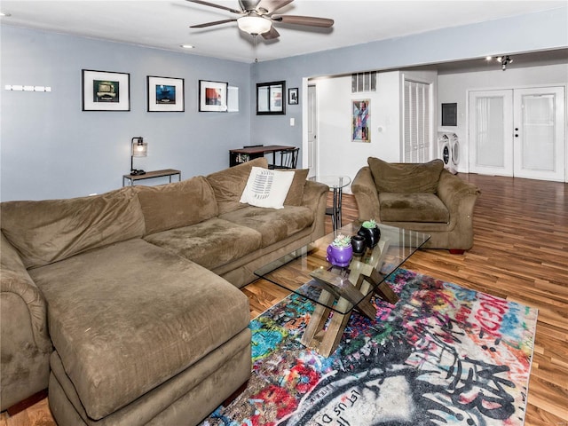 living room featuring washer and clothes dryer, ceiling fan, and hardwood / wood-style floors