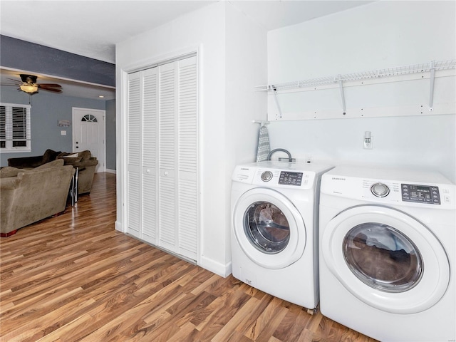 laundry room featuring ceiling fan, washing machine and dryer, and wood-type flooring