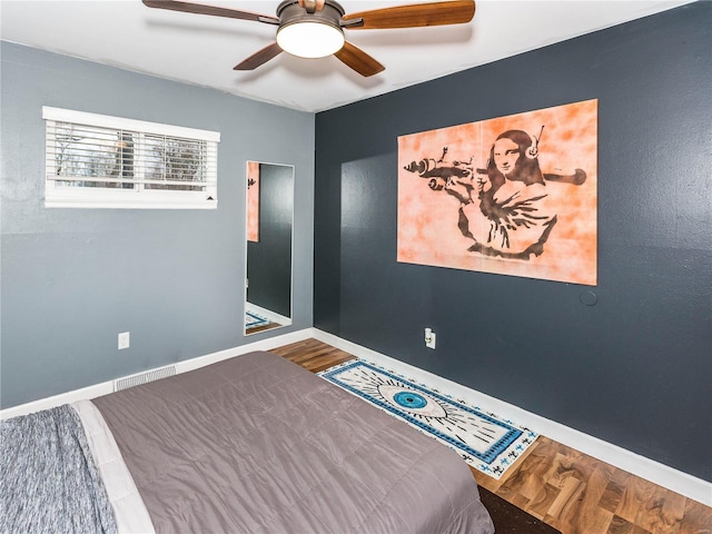 bedroom featuring hardwood / wood-style floors and ceiling fan