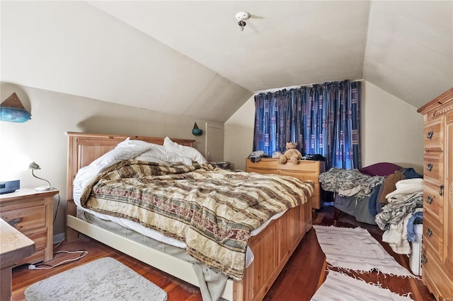 bedroom featuring dark wood-type flooring and vaulted ceiling