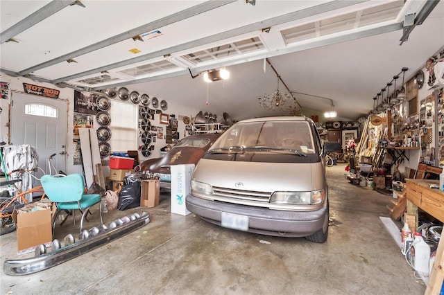 garage with a workshop area and a garage door opener