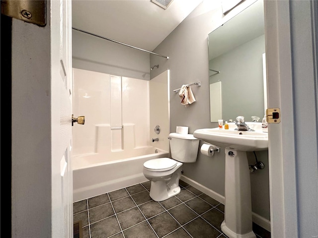 bathroom with toilet, tile patterned floors, and shower / washtub combination