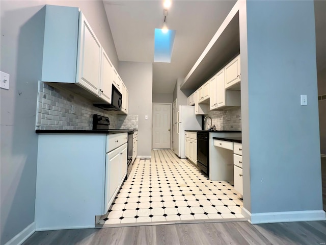 kitchen featuring decorative backsplash, white cabinetry, and black appliances