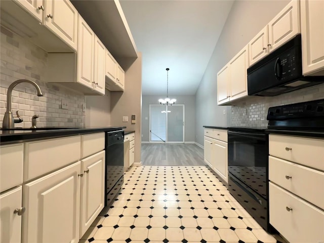 kitchen featuring sink, an inviting chandelier, white cabinetry, and black appliances