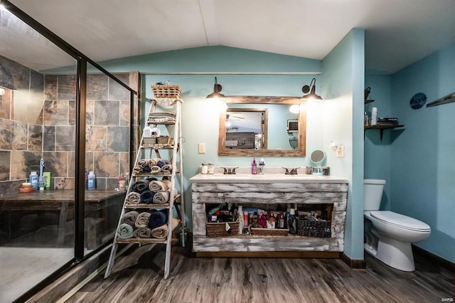 bathroom featuring an enclosed shower, vanity, vaulted ceiling, wood-type flooring, and toilet