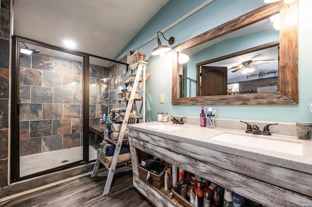 bathroom with hardwood / wood-style floors, vanity, an enclosed shower, and lofted ceiling