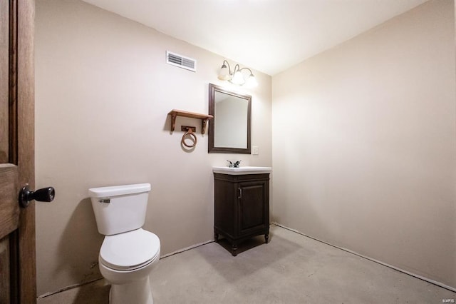 bathroom featuring concrete flooring, vanity, and toilet