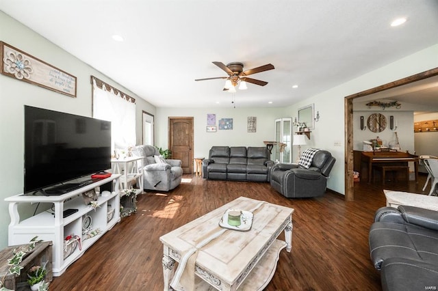 living room with ceiling fan and dark wood-type flooring