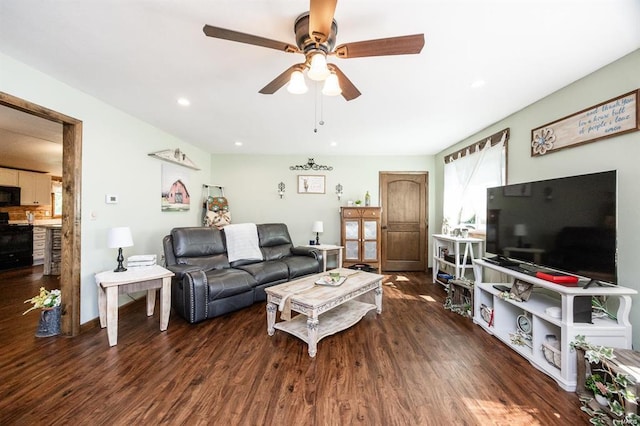 living room featuring ceiling fan and dark wood-type flooring