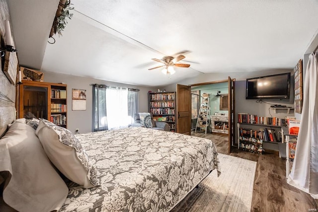 bedroom featuring ceiling fan, dark hardwood / wood-style flooring, and lofted ceiling