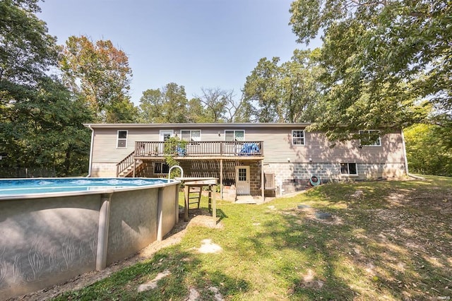 back of property featuring a lawn and a pool side deck