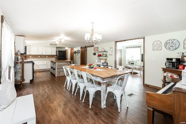 dining area featuring dark hardwood / wood-style flooring and a chandelier